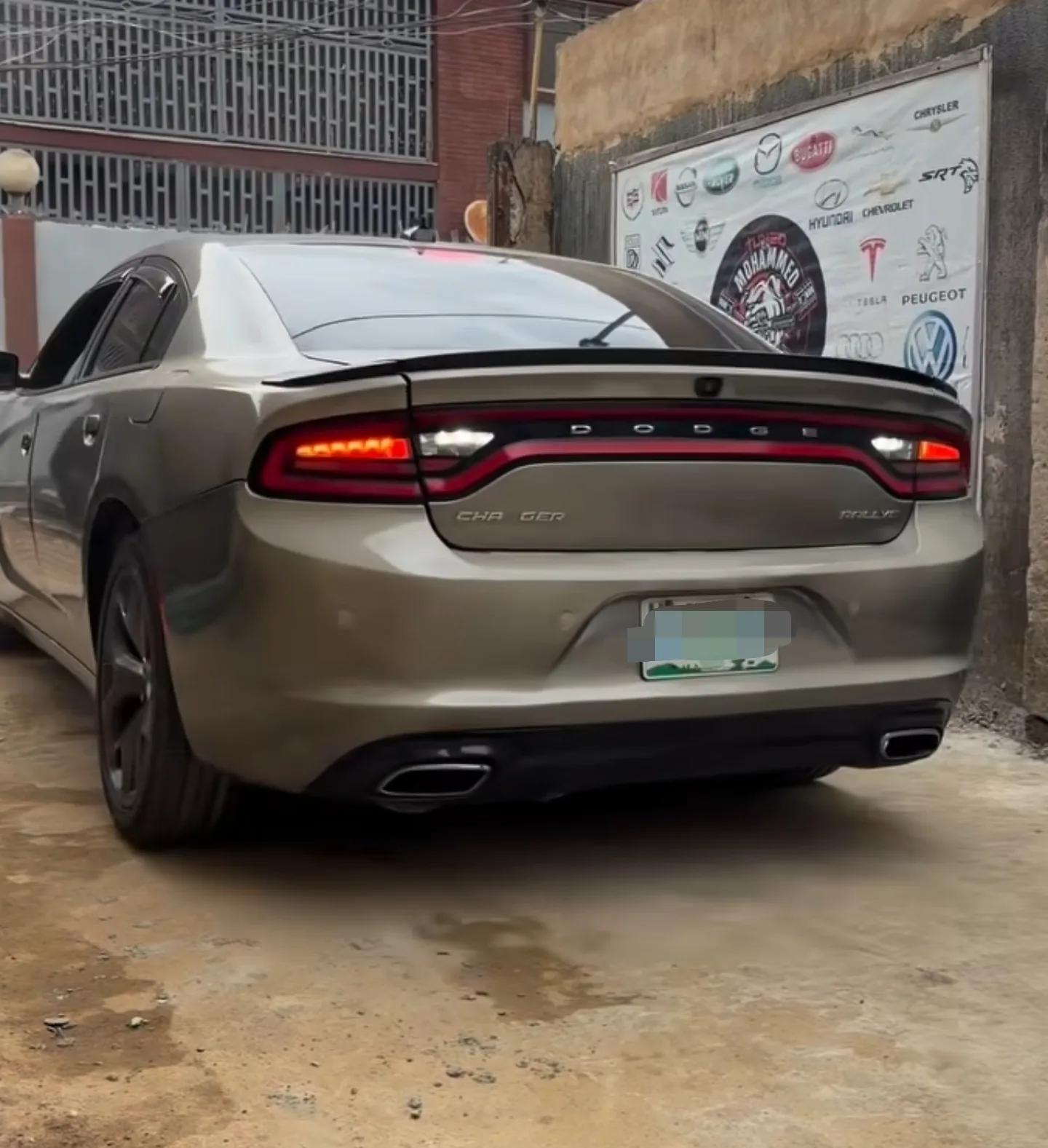 Dodge Charger arriving at Mohammed Lexus with its original 2-year-old silver wrap intact