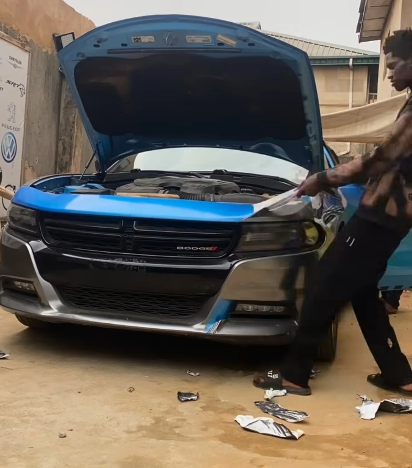 Dodge Charger bonnet stripping in progress at Mohammed Lexus, showing paint condition during the removal process