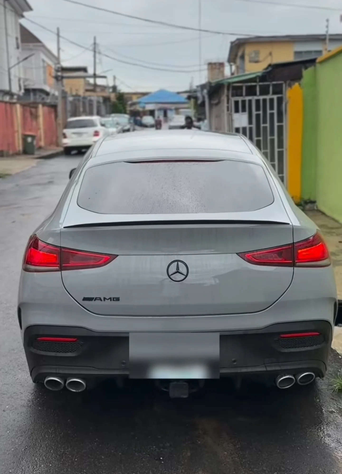 Mercedes GLE 53 AMG full rear view in completed Nardo Grey finish with quad exhausts Lagos street