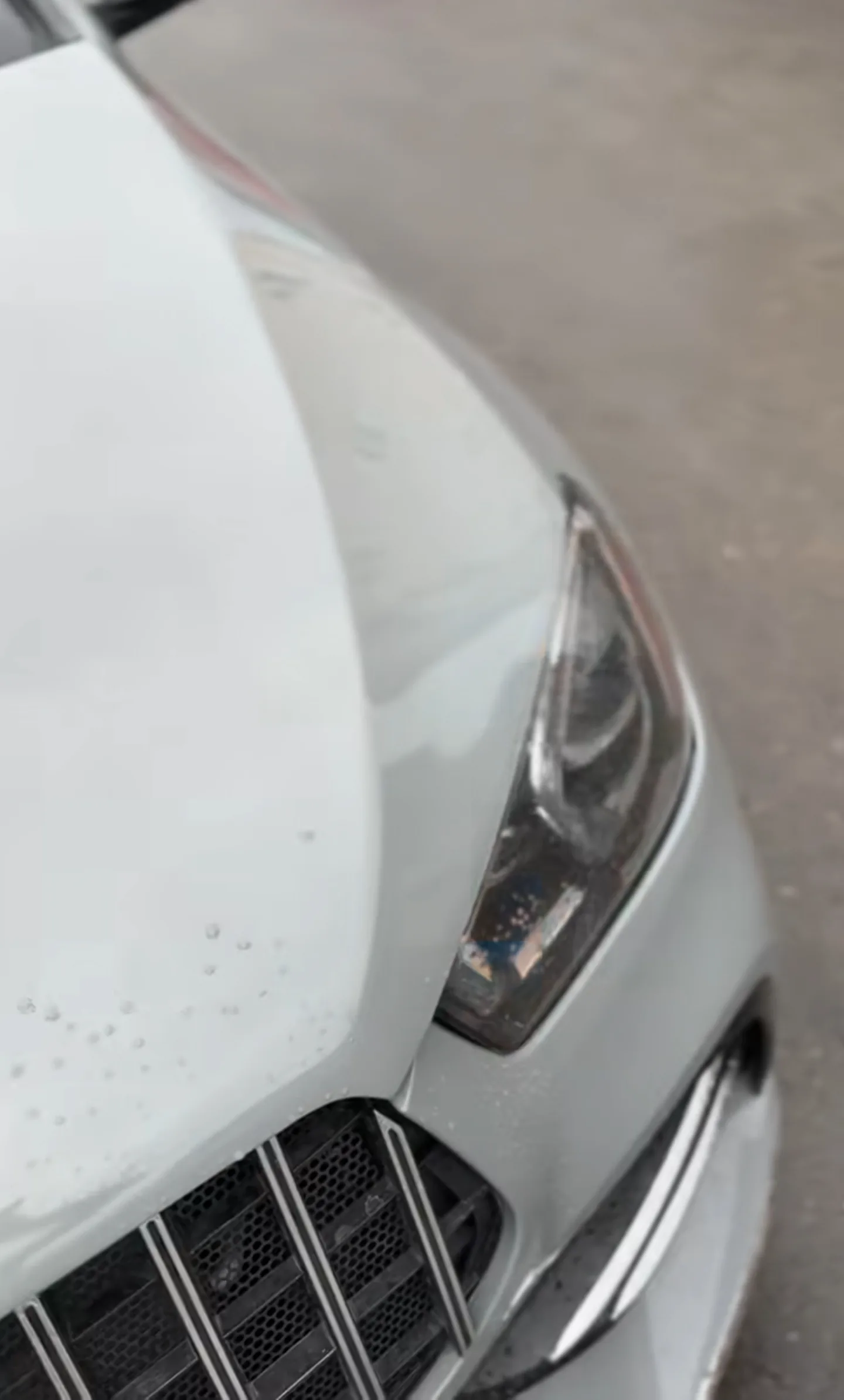 Close-up of Mercedes GLE 53 bonnet and headlight in completed Nardo Grey finish after colour change