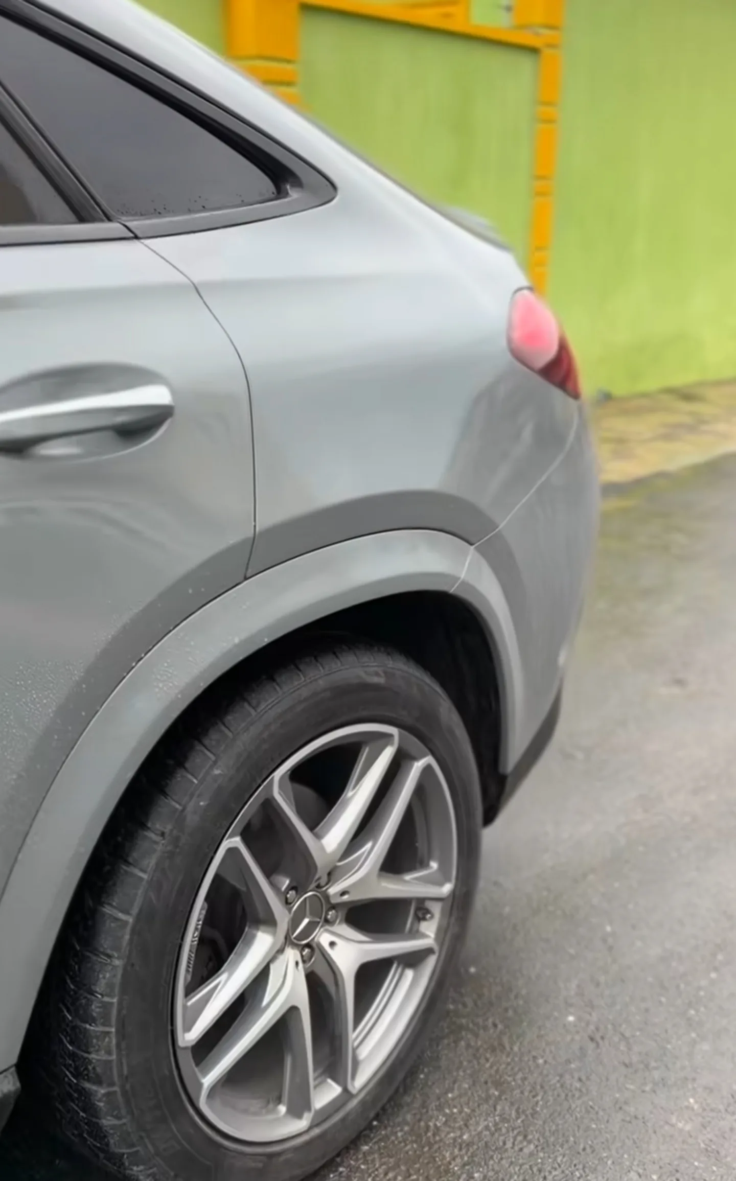 Mercedes GLE 53 rear quarter panel in completed Nardo Grey colour change, rear wheel and taillight visible