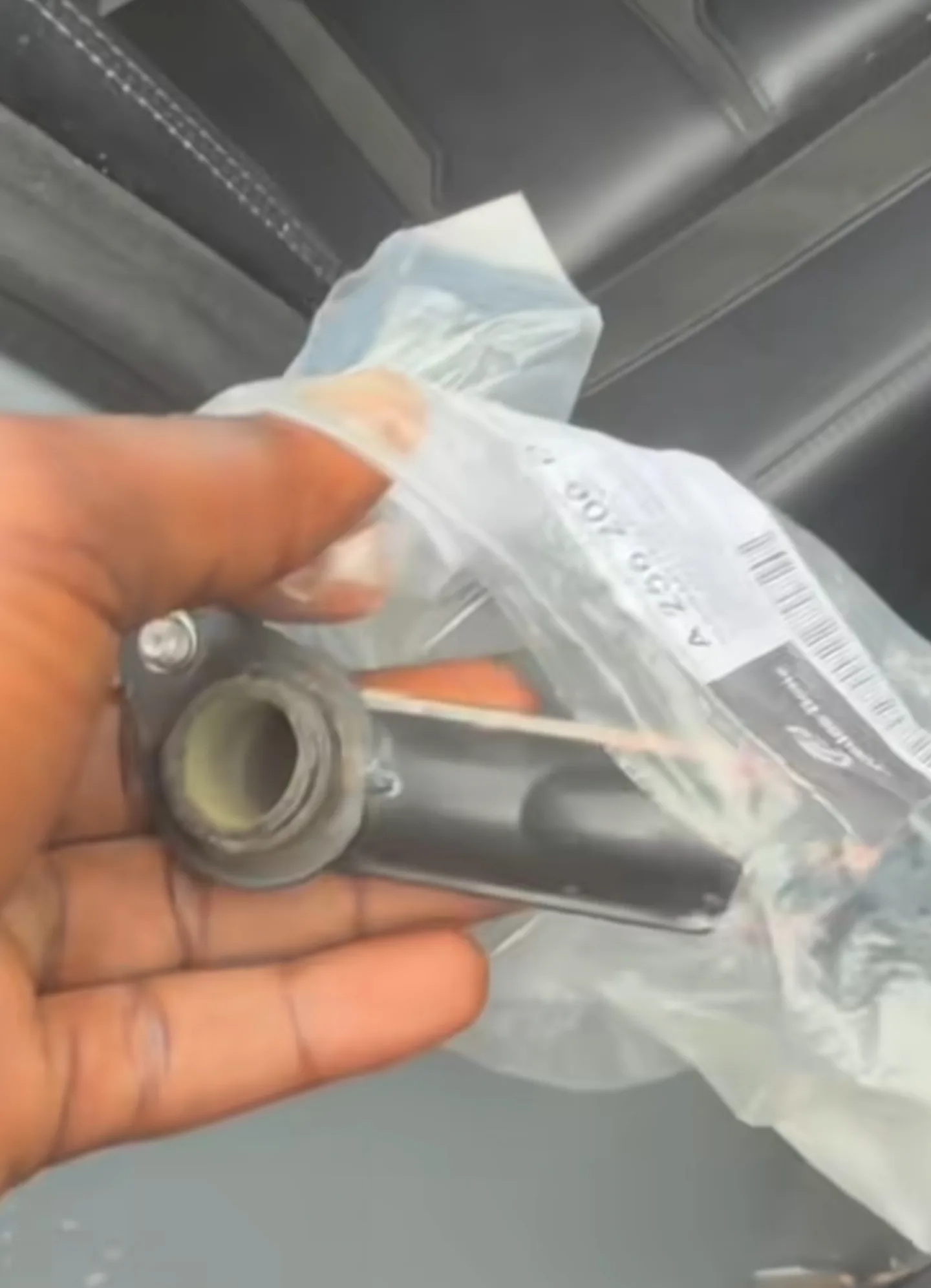 Old damaged coolant hose removed from Mercedes GLE 53 AMG engine