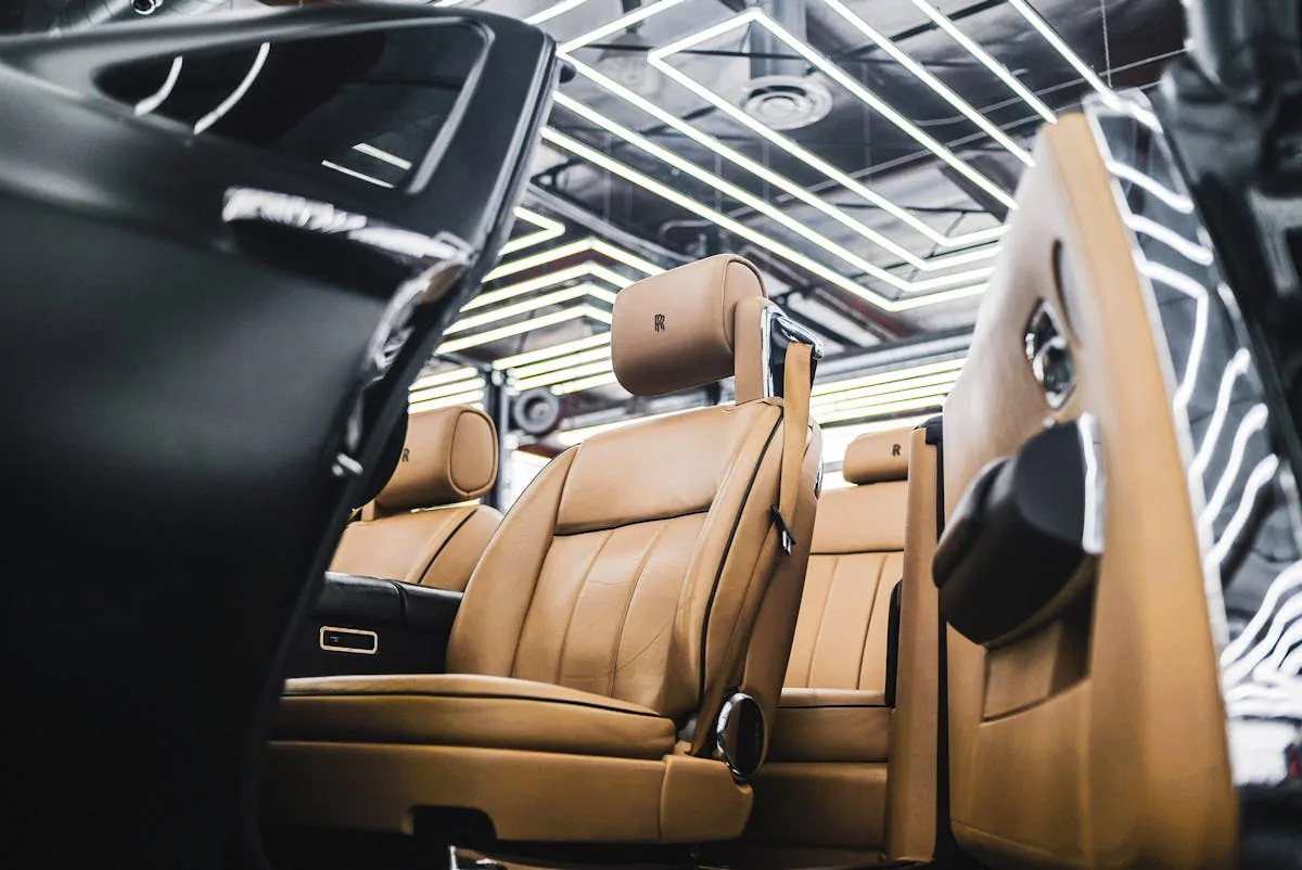 Luxury premium car interior rolls royce tan leather seat open door ambient ceiling showroom