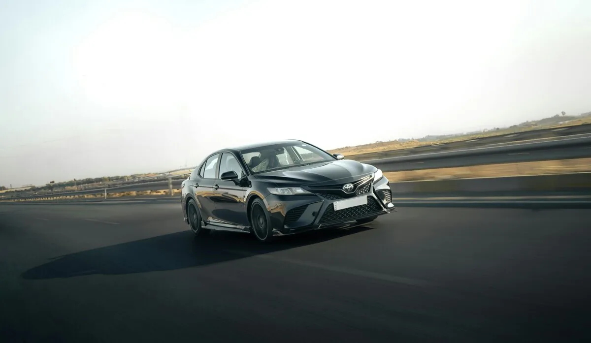 Toyota Camry modern sedan exterior on highway three-quarter view Nigeria